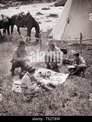 1920s 1930s TWO MEN COWBOY TRAIL HANDS AND TWO YOUNG WOMEN DUDE RANCH GUESTS EATING LUNCH BY TEPEE AND HORSES ALBERTA CANADA - c4927 HAR001 HARS VACATION LIFESTYLE FEMALES RURAL HEALTHINESS COPY SPACE FRIENDSHIP FULL-LENGTH LADIES PHYSICAL FITNESS PERSONS SADDLE MALES WESTERN B&W FREEDOM TIME OFF WIDE ANGLE HAPPINESS MAMMALS HIGH ANGLE ADVENTURE LEISURE CUSTOMER SERVICE TRIP AND GETAWAY CHOICE RECREATION BY GREENHORN GUESTS HOLIDAYS OCCUPATIONS SUPPER TEPEE CONCEPTUAL DUDE RANCH GUIDES STYLISH ALBERTA MAMMAL MID-ADULT MID-ADULT WOMAN RELAXATION ROCKY MOUNTAINS TOGETHERNESS VACATIONS Stock Photo