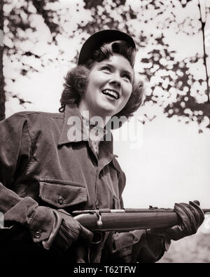 1950s SMILING YOUNG WOMAN WEARING HUNTING GARB HOLDING 22 CALIBER SMALL GAME BOLT ACTION RIFLE - h2149 CLE003 HARS JOY LIFESTYLE FEMALES RURAL COPY SPACE HALF-LENGTH LADIES SHOOT PERSONS RIFLE HUNTER EXPRESSIONS B&W HAPPINESS CHEERFUL ADVENTURE CORDUROY EXCITEMENT LOW ANGLE RECREATION ANTICIPATION SMILES CONCEPTUAL GARB JOYFUL RIFLES SHOOTER EAGER FIREARM FIREARMS YOUNG ADULT WOMAN 22 CALIBER BLACK AND WHITE BOLT ACTION CAUCASIAN ETHNICITY OLD FASHIONED Stock Photo