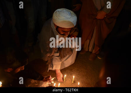 A Kashmiri Shia Muslim cleric seen lighting candles during a Protest in Srinagar. Shia protesters held a candle light vigil in Srinagar against the mass execution of 37 individuals in Saudi Arabia. According to Saudi Press Agency, those executed were accused of 'forming a terrorist cell' and attacking a security outpost, killing a number of officers.