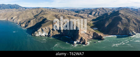 Seen from an aerial perspective, the cold waters of the Pacific Ocean wash against the rocky Northern California coastline in Marin. Stock Photo