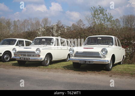 A PAIR OF WHITE CLASSIC FORD CORTINA MARK 1 CARS ONE SALOON AND 1 ESTATE Stock Photo