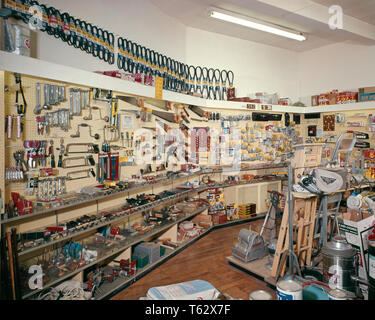 1960s 1970s INTERIOR OF RETAIL HARDWARE STORE STOCKED FROM FLOOR TO CEILING WITH HAND AND POWER TOOLS  - ki716 HAR001 HARS PASTIME PLEASURE OF ON OCCUPATIONS HARDWARE CONCEPTUAL STILL LIFE STYLISH SUPPORT DIY STOCKED CREATIVITY FLOOR TO CEILING HOME IMPROVEMENT RELAXATION AMATEUR ENJOYMENT HAR001 OLD FASHIONED Stock Photo