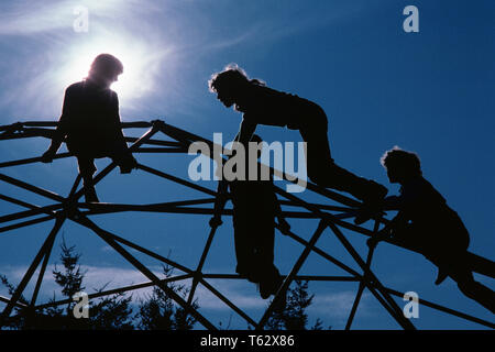 1980s FOUR ANONYMOUS SILHOUETTED KIDS CLIMBING ON GEODESIC JUNGLE GYM  - kj10038 LGA001 HARS ATHLETE LIFESTYLE JUNGLE FEMALES RURAL HEALTHINESS HOME LIFE ATHLETICS COPY SPACE PEOPLE CHILDREN FRIENDSHIP FULL-LENGTH ADOLESCENT MALES RISK ATHLETIC CONFIDENCE CLIMBER SUCCESS TEMPTATION ACTIVITY STRUCTURE HAPPINESS PHYSICAL ADVENTURE CLIMB STRENGTH SUPPORTER SILHOUETTED COURAGE ON PRETEEN CONCEPTUAL ATHLETES FLEXIBILITY MUSCLES SUPPORT ANONYMOUS GEODESIC C GROWTH JUVENILES TOGETHERNESS YOUNGSTER JUNGLE GYM OLD FASHIONED Stock Photo