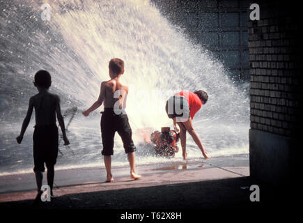 1950s 1960s 3 ANONYMOUS CHILDREN PLAYING IN WATER SPRAYED FROM OPEN SIDEWALK FIRE HYDRANT - kj1227 LAN001 HARS UNITED STATES OF AMERICA MALES NORTH AMERICA SUMMERTIME HAPPINESS SILHOUETTED AND EXCITEMENT RECREATION IN HYDRANT FIRE HYDRANT CITIES SPRAYED ANONYMOUS JUVENILES SPRAY TOGETHERNESS OLD FASHIONED Stock Photo