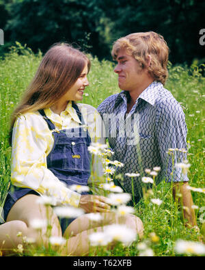 1970s SMILING ROMANTIC TEEN COUPLE SITTING TOGETHER IN FIELD OF DAISIES AND WILD FLOWERS - kj6263 HAR001 HARS NOSTALGIA OLD FASHION 1 JUVENILE FACIAL COMMUNICATION STRONG WILD PLEASED JOY LIFESTYLE FEMALES RURAL HALF-LENGTH PERSONS CARING MALES TEENAGE GIRL TEENAGE BOY EXPRESSIONS DATING DAISIES TEMPTATION DREAMS HAPPINESS CHEERFUL DISCOVERY AND CHOICE EXCITEMENT IN OF ATTRACTION SMILES CONNECTION COURTSHIP CONCEPTUAL JOYFUL STYLISH TEENAGED PERSONAL ATTACHMENT POSSIBILITY QUEEN ANNE'S LACE AFFECTION EMOTION GROWTH JUVENILES SMIRKING SOCIAL ACTIVITY CAUCASIAN ETHNICITY COURTING HAR001 Stock Photo