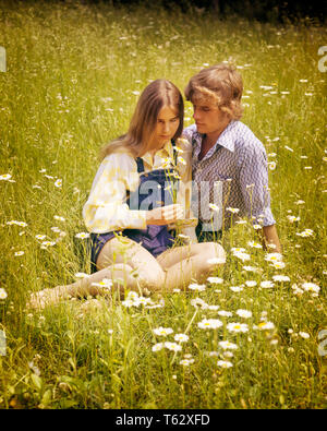 1970s ROMANTIC TEEN COUPLE IN FIELD OF DAISIES - kj6266 HAR001 HARS COPY SPACE FRIENDSHIP HALF-LENGTH PERSONS CARING MALES TEENAGE GIRL TEENAGE BOY DENIM SUMMERTIME DATING DAISIES HAPPINESS HIGH ANGLE HAIRSTYLE ATTRACTION RELATIONSHIPS CONNECTION COURTSHIP HAIRSTYLES STYLISH TEENAGED POSSIBILITY JUVENILES SOCIAL ACTIVITY TOGETHERNESS CAUCASIAN ETHNICITY COURTING HAR001 OLD FASHIONED Stock Photo
