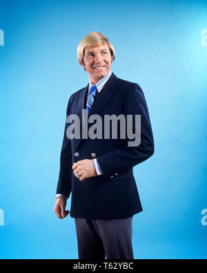 1970s SMILING BLOND BUSINESSMAN WEARING NAVY BLUE DOUBLE BREASTED JACKET STRIPED SHIRT AND TIE  - ks8209 HAR001 HARS STRIPED STUDIO SHOT NAVY HEALTHINESS COPY SPACE HALF-LENGTH PERSONS MALES CONFIDENCE EXPRESSIONS SUIT AND TIE SELLING HAPPINESS CHEERFUL AND DOUBLE BREASTED OCCUPATIONS SMILES JOYFUL STYLISH BREASTED MID-ADULT MID-ADULT MAN SALESMEN YOUNG ADULT MAN CAUCASIAN ETHNICITY HAR001 OLD FASHIONED Stock Photo