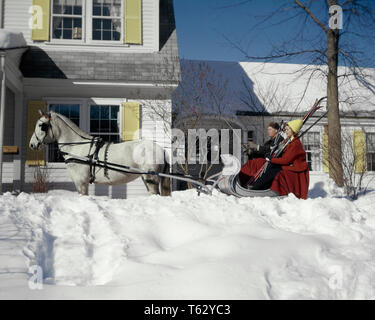 1960s COUPLE MAN WOMAN RED COAT HOLDING SKIS WHITE ONE HORSE-DRAWN OPEN SLEIGH COUNTRY HOUSE INN SNOW VACATION - kw2708 LAW001 HARS PAIR ROMANCE BEAUTY COLOR OLD TIME NOSTALGIA OLD FASHION 1 WELCOME HORSES SKIS VACATION JOY LIFESTYLE FEMALES MARRIED RURAL SPOUSE HUSBANDS GROWNUP COPY SPACE FRIENDSHIP HALF-LENGTH LADIES PERSONS GROWN-UP MALES TRANSPORTATION SLEIGH WINTERTIME WINTER SEASON TIME OFF HAPPINESS MAMMALS ADVENTURE TRIP GETAWAY EXCITEMENT EXTERIOR HORSE-DRAWN OPPORTUNITY DRAWN HOLIDAYS INN CONCEPTUAL STYLISH EQUINE CREATURE CUTTER MAMMAL MAN  MID-ADULT MID-ADULT MAN MID-ADULT WOMAN Stock Photo
