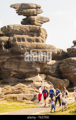 Families men women and children enjoying the day out at Brimham rocks a National Trust location in Nidderdale in the Yorkshire Dales England UK Stock Photo