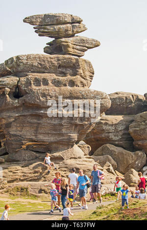 Families men women and children enjoying the day out at Brimham rocks a National Trust location in Nidderdale in the Yorkshire Dales England UK Stock Photo