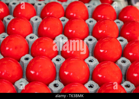 Orthodox Easter. Red eggs in carton packaging, closeup view, full background Stock Photo