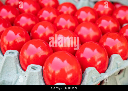 Orthodox Easter. Red eggs in carton packaging, closeup view, full background Stock Photo