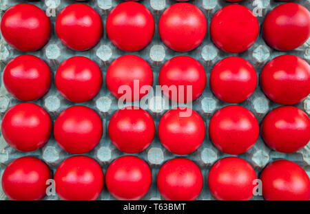 Orthodox Easter. Red eggs in carton packaging, top view, full background Stock Photo