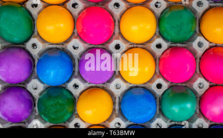 Orthodox Easter. Colorful eggs in carton packaging, top view, full background Stock Photo