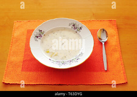 czech white milk and dill soup with table spoon Stock Photo