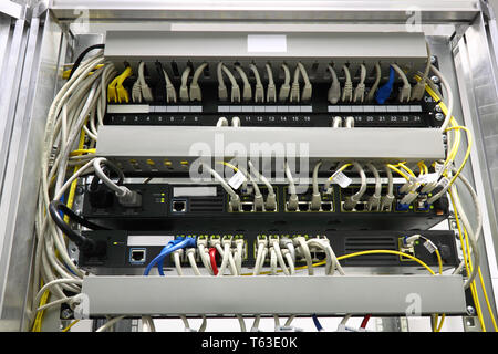 connected switches in technology room with fiber optic SFP ports Stock Photo