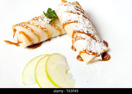 Pancakes with apples on a black background. Restaurant menu. Stock Photo