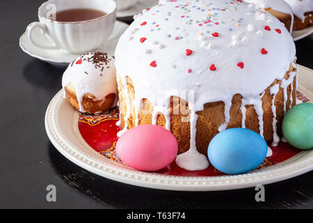 Easter cake and colorful eggs close-up. Happy Easter family breakfast concept. Selective focus. Stock Photo