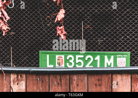 Registration number plate Upper Austria on the wall of an abandoned barn Stock Photo