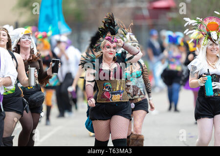 New Orleans, Louisiana, USA - February 23, 2019: Mardi Gras Parade, Members of The Dames De Perlage, Wearing colorful outfits walking down the street  Stock Photo