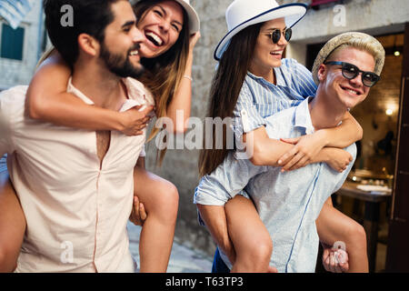 Group of happy friends enjoying sightseeing tour in the city. Stock Photo