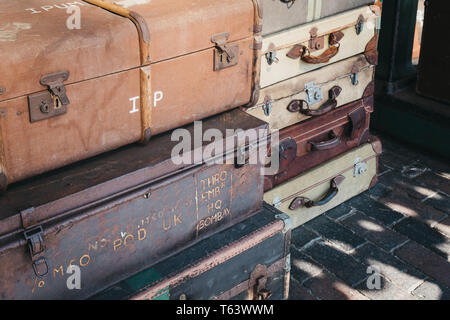Sheringham, UK - April 21, 2019: Retro decorative suitcases on the platform of Sheringham train station on a sunny spring day. Sheringham is an Englis Stock Photo
