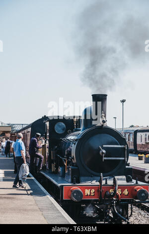Sheringham, UK - April 21, 2019: Staff and passenger by The Poppy Line steam train, also known as the North Norfolk Railway, a Heritage Steam Railway  Stock Photo