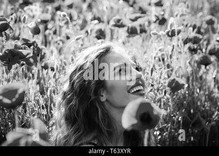 beautiful woman on poppy field with long hair Stock Photo