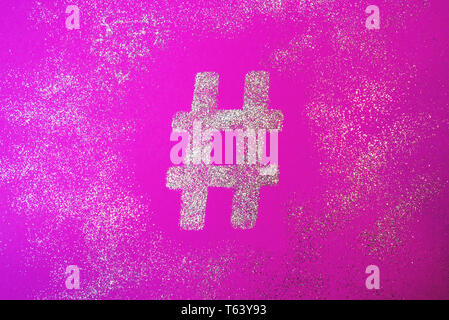Hashtag sign. Silver hashtag symbol on trendy pink background Stock Photo