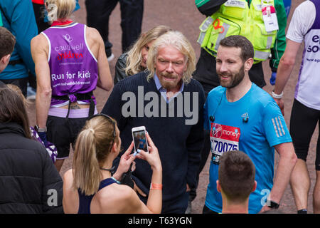 Sir Richard Branson at finish of the 2019 Virgin Money London Marathon, over 40,000 runners took part in the marathon in London this weekend. Stock Photo