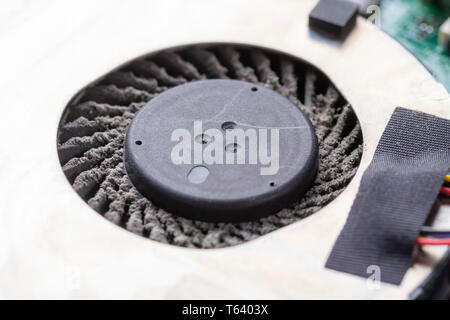 Dusty fan of a laptop close up. Disassembling and cleaning the laptop with your hands at home Stock Photo