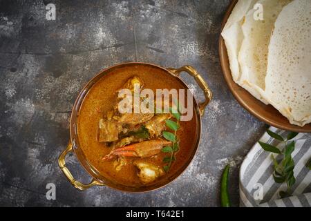 Kerala Spicy Crab curry served with Appam Stock Photo