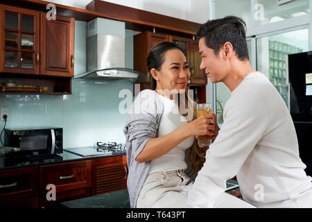 Cheerful flirting couple in kitchen Stock Photo