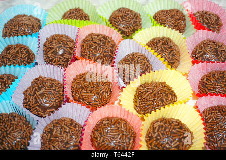 Delicious Brazilian chocolate ball Brigadier made from condensed milk and chocolate hail coating in colorful paper tray Christmas treat sweet dessert Stock Photo