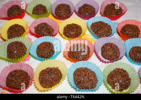 Delicious Brazilian chocolate ball Brigadier made from condensed milk and chocolate hail coating in colorful paper tray Christmas treat sweet dessert Stock Photo