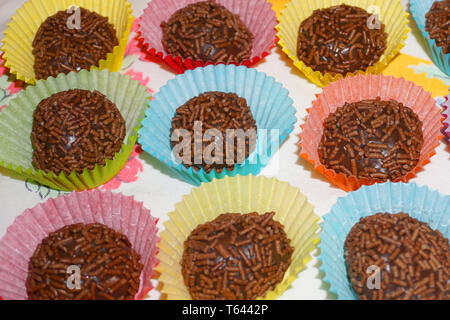 Delicious Brazilian chocolate ball Brigadier made from condensed milk and chocolate hail coating in colorful paper tray Christmas treat sweet dessert Stock Photo
