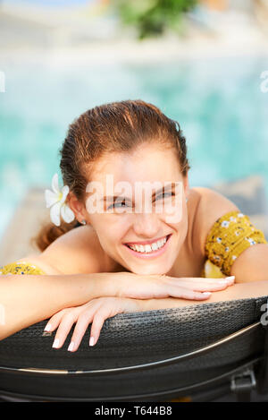 Woman resting near swimming pool Stock Photo