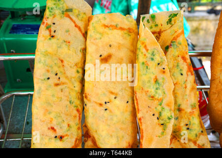Banh trang nuong - Vietnamese street food with grilled rice paper egg onion small shrimp pork floss Stock Photo