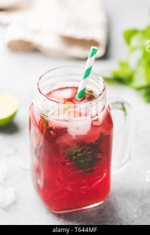 Berry Ice Tea In Glass Cup With Drinking Straw. Selective Focus, Vertical Orientation