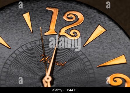 Minute, hour and second hands on a watch face showing nearly 12 o'clock midnight or midday. Macro clock face. Time concept. Stock Photo