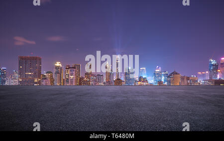 Bangkok urban cityscape skyline night scene with empty asphalt floor on front Stock Photo