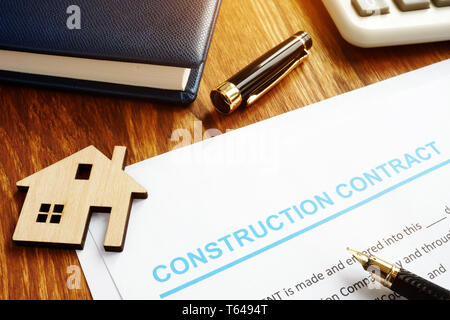 Construction contract, model of house and calculator. Stock Photo
