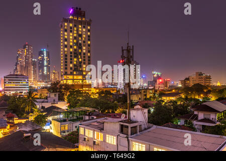 As the temperature cools in evening the skyline of Colombo, the capital city of Sri Lanka, lights up at dusk. Colombo is Sri Lanka's one true metropol Stock Photo