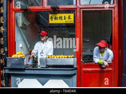 Beijing, China. 18th Oct, 2006. Vendors offer their food specialties to passersby in the Donghuamen Night Market in Beijing. Credit: Arnold Drapkin/ZUMA Wire/Alamy Live News