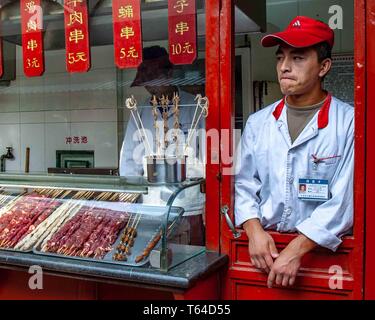 Beijing, China. 18th Oct, 2006. Vendors offer their food specialties to passersby in the Donghuamen Night Market in Beijing. Credit: Arnold Drapkin/ZUMA Wire/Alamy Live News