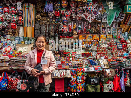 Beijing, China. 18th Oct, 2006. A vendor in the Donghuamen Night Market in Beijing stands beside her stall loaded with merchandise. Credit: Arnold Drapkin/ZUMA Wire/Alamy Live News