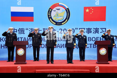 (190429) -- QINGDAO, April 29, 2019 (Xinhua) -- Representatives of both China and Russia salute at the welcome ceremony for Russian navy vessels in Qingdao, east China's Shandong Province, April 29, 2019. Russian naval vessels arrived in Qingdao on Monday to participate in the Sino-Russian 'Joint Sea-2019' exercise.      The exercise will focus on joint sea defense, which aims to consolidate and develop the China-Russia comprehensive strategic partnership of coordination, deepen pragmatic naval cooperation, and improve their capabilities to jointly respond to security threats at sea.     Two s Stock Photo