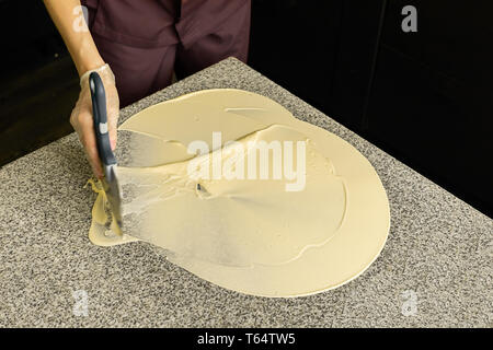 Tempering white chocolate. The process of making handmade chocolates. Selective focus. Stock Photo