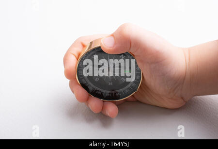 Compass tool in toddler hand on white Stock Photo