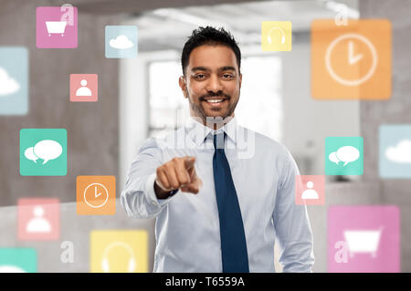 businessman pointing to you or app icons at office Stock Photo